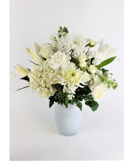 This remarkable arrangement is expertly crafted featuring roses, mums, lily, and hydrangea. 