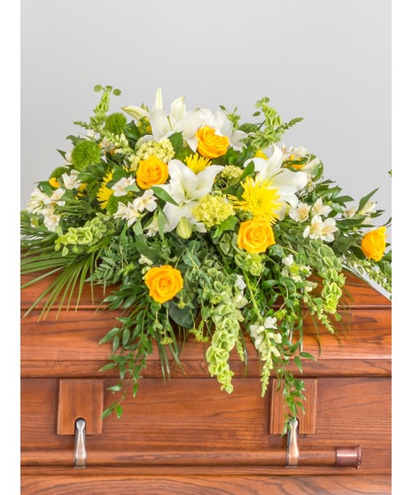 Classic casket designed with a mix or premium red and white flowers including hydrangea, roses, and lilies.