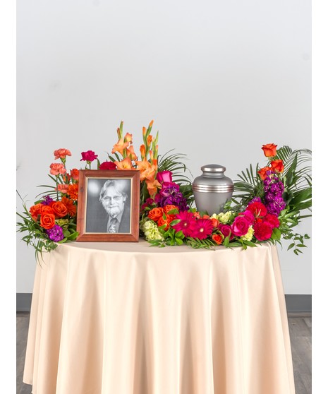 Perfect mix of roses, lilies, and daisy's in striking shades of pinks and purples. This design is perfect for and urn placement at a memorial service. 