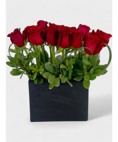 Rich red roses are arranged in a gleaming golden vase.  Accented by glimmering gold floss and greens, it's sure to dazzle!