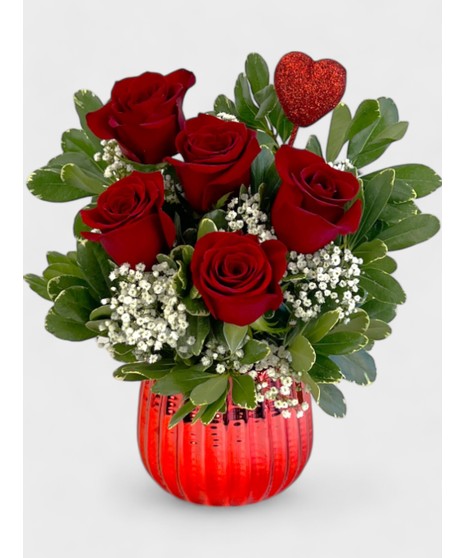 Rich red roses are arranged in a gleaming golden vase.  Accented by glimmering gold floss and greens, it's sure to dazzle!