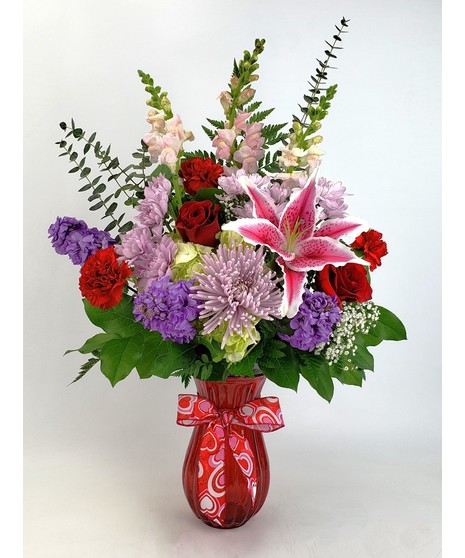 This  Irresistible arrangement full of fragrant stargazer lilies, beautiful white hydrangea, vibrant red tulips and captivating  roses