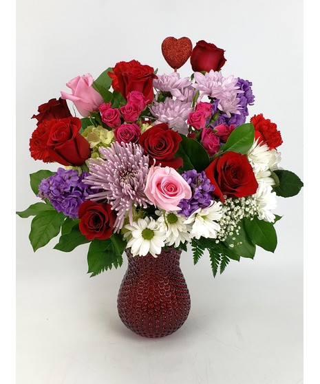 This  Irresistible arrangement full of fragrant stargazer lilies, beautiful white hydrangea, vibrant red tulips and captivating  roses