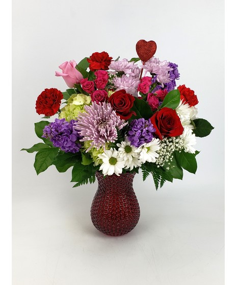 This  Irresistible arrangement full of fragrant stargazer lilies, beautiful white hydrangea, vibrant red tulips and captivating  roses