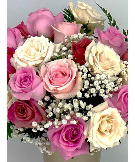 Vintage Garden style roses designed in a pink dimple pattern Vase. Antique hues of Lavender, pink and cream Roses mixed with seasonal cut garden accents. 